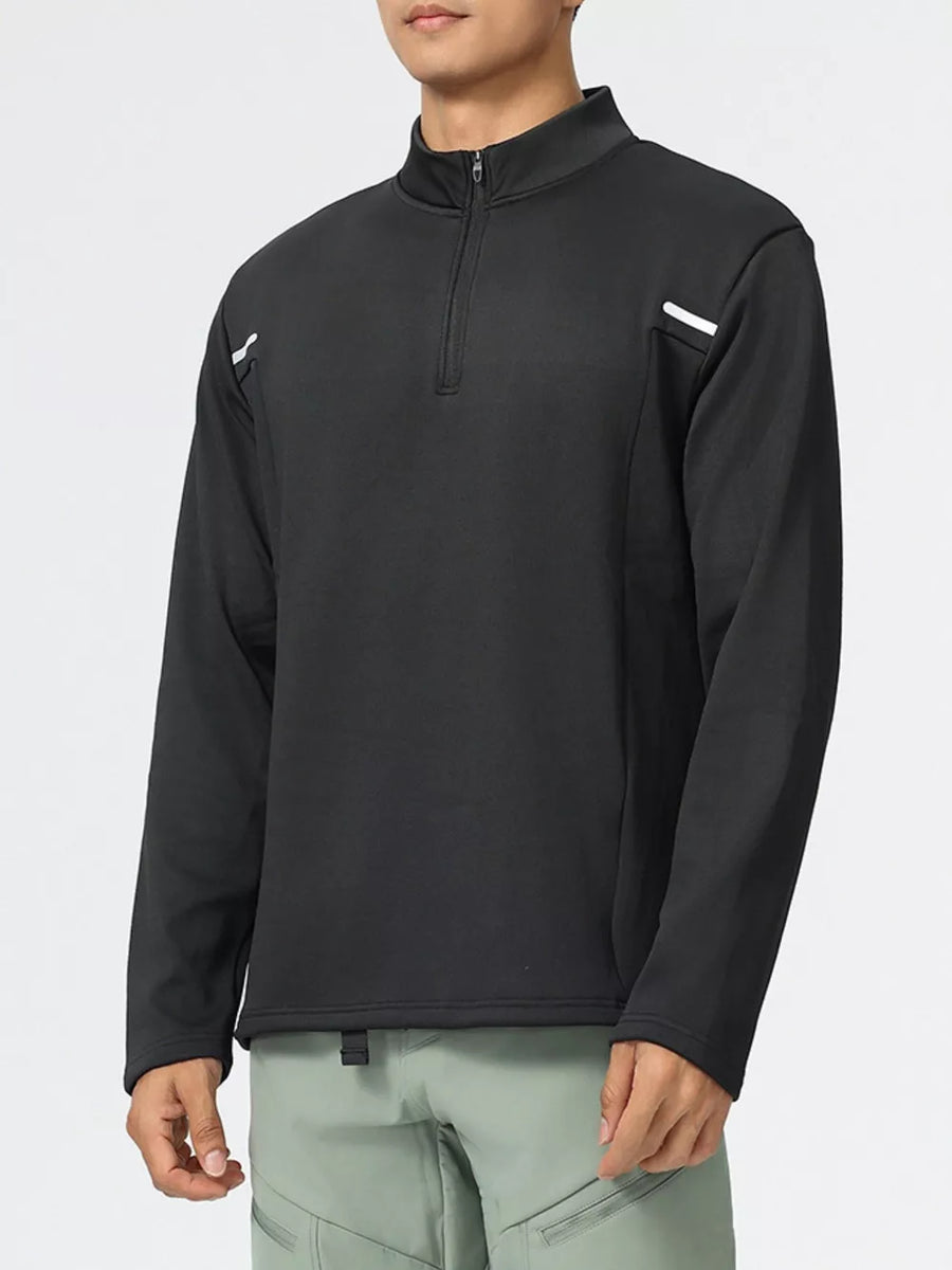 Men's black half-zip sweatshirt with reflective shoulder details.