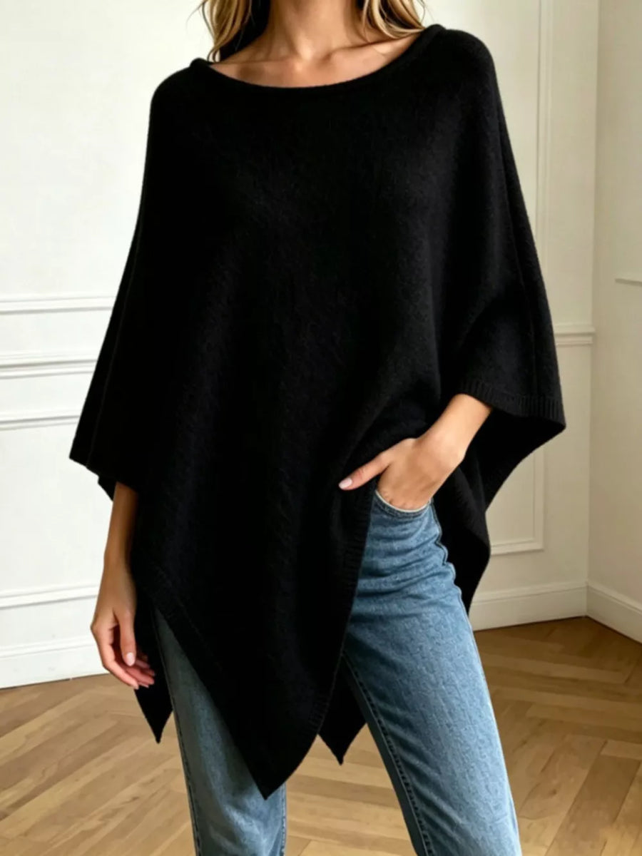 poncho in black featuring asymmetrical hem and oversized fit