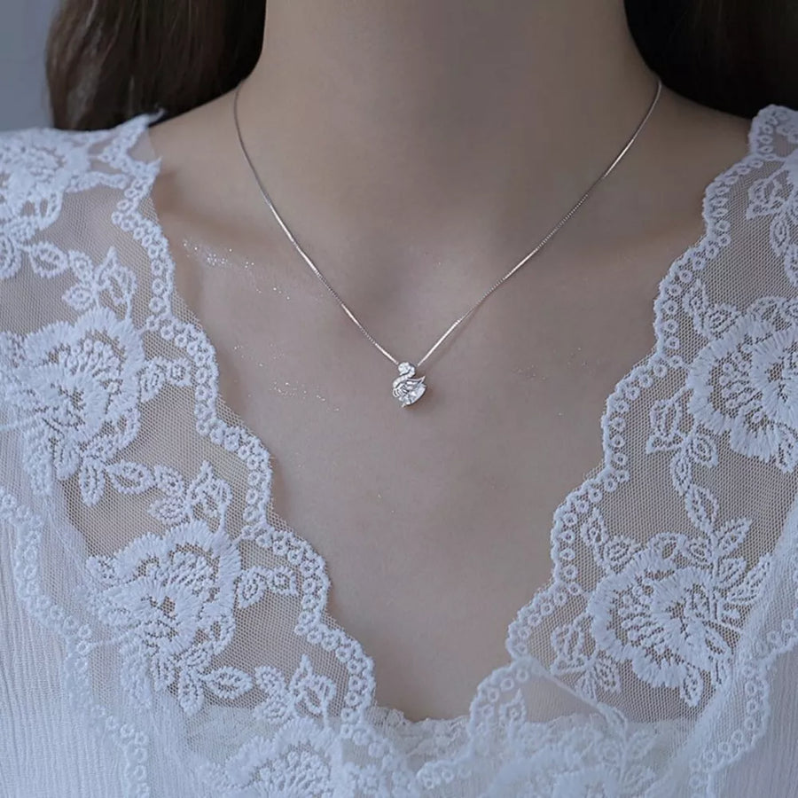 Silver swan pendant necklace with zircon detail on a delicate chain.