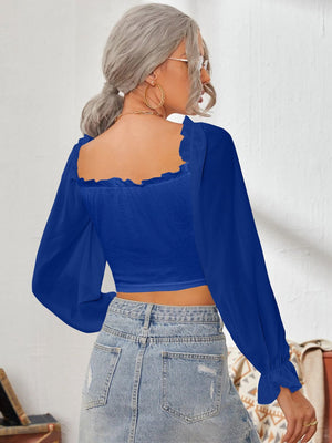 Royal blue bustier blouse with square neckline and long puff sleeves with ruffled cuffs.