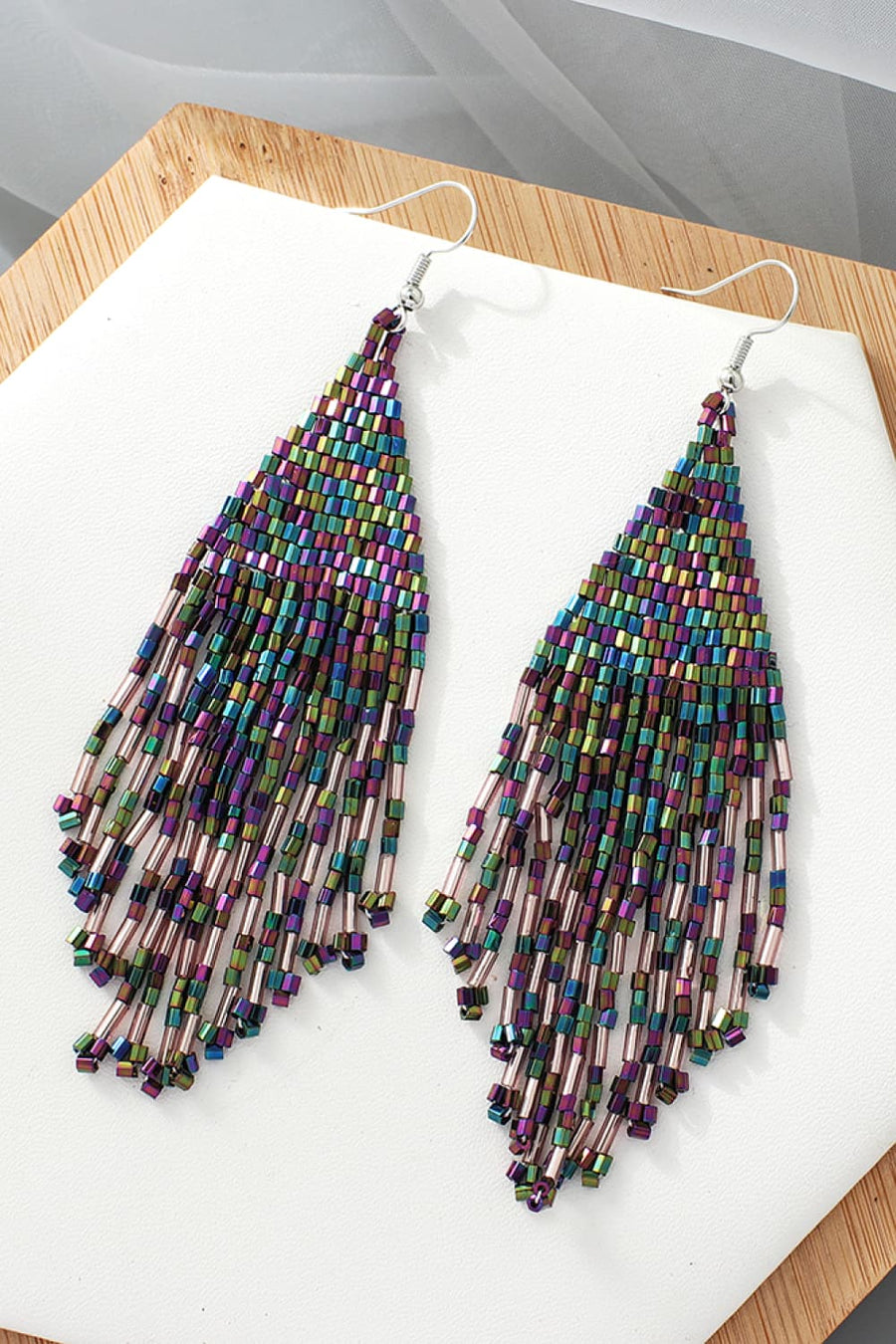 Prismatic beaded fringe earrings with multicolor beads and dangling strands.
