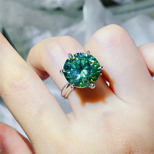 Green moissanite solitaire ring in 925 sterling silver with six prongs.
