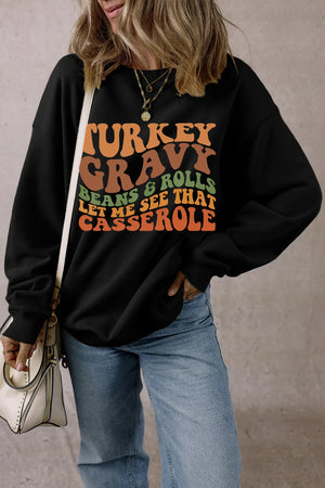 Black crewneck sweatshirt with Thanksgiving graphic text.