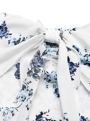 White floral romper with blue flowers, smocked detail and tie-front neckline.