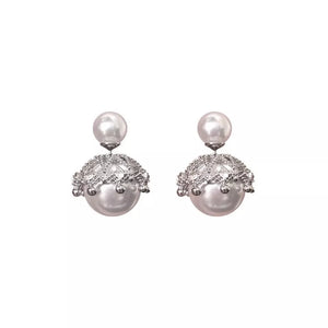 Pearl stud earrings with crown-inspired crystal embellishments and dangling pearls.