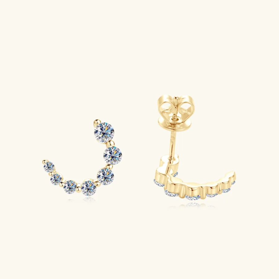 Gold Celestial Arc Moissanite Earrings with sparkling stones in a curved design.