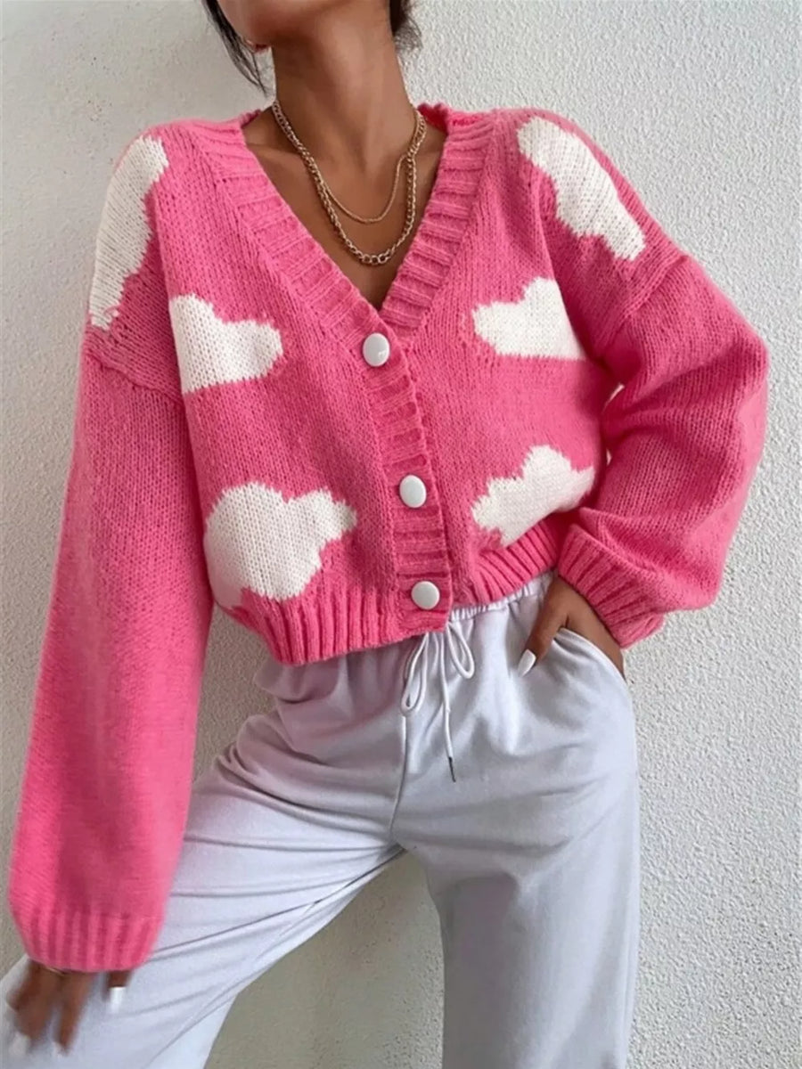 Hot pink acrylic button cardigan with white cloud pattern and V-neck.