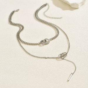 Silver layered Y-shaped pendant necklace with interlocking rings and cubic zirconia detail.