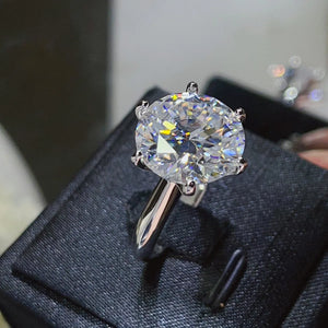 Solitaire engagement ring with large round diamond on 925 silver band.
