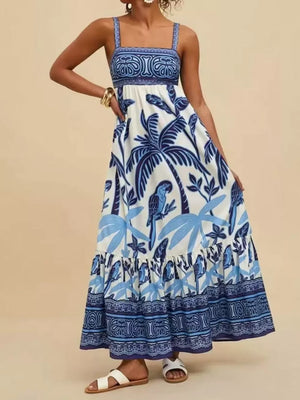 Tropical print maxi dress with square neck and tiered skirt in white with blue parrots and palm leaves.