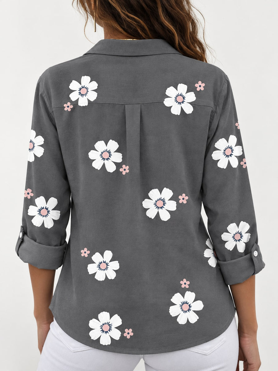 white button-down shirt featuring buttoned and floral