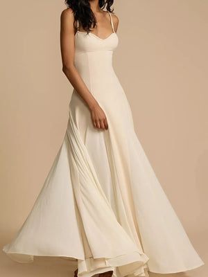 Elegant ivory sweetheart neck maxi dress with spaghetti straps and flowing skirt.