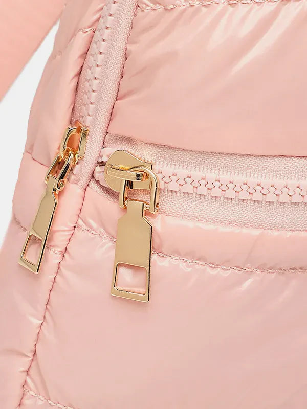 Glossy padded sling bag in pink with gold zippers and quilted detail.