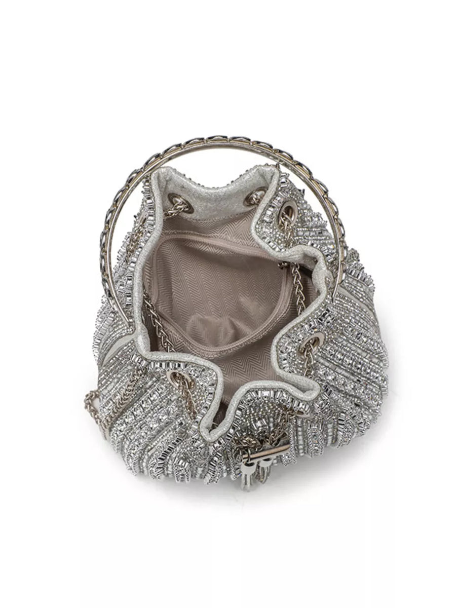 Silver rhinestone embellished mini bucket crossbody bag with chain handle and strap.
