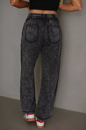 80% cotton, 20% polyester Care instructions: Machine wash cold barrel pants in Black with relaxed silhouette