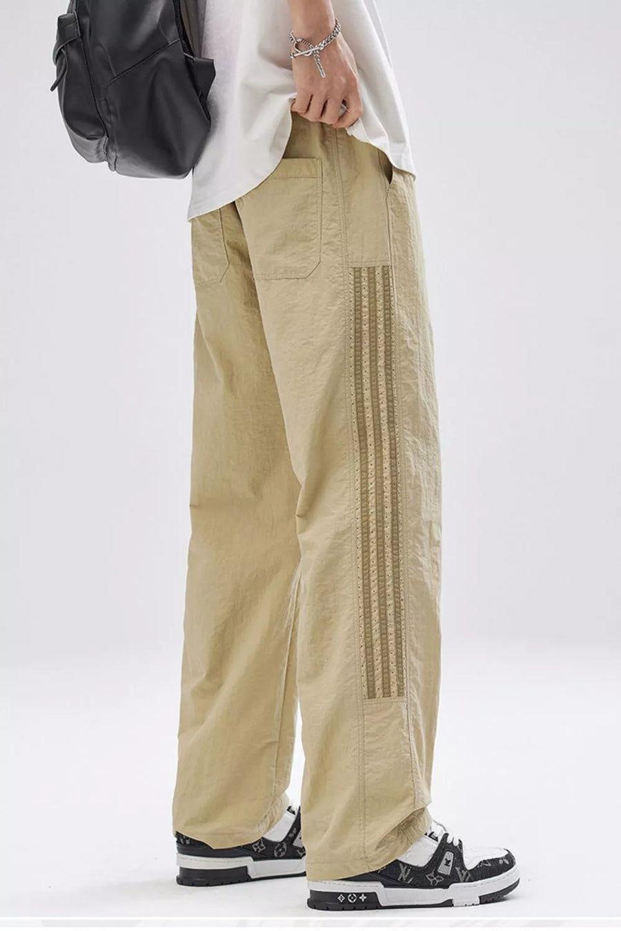 Men's khaki wide-leg cargo pants with decorative side stripe detail and front pockets.