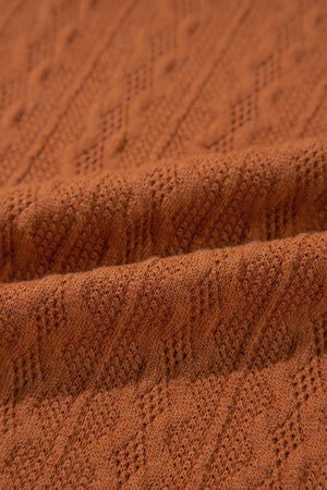 Terracotta open front cardigan with diamond knit detail and open weave texture.