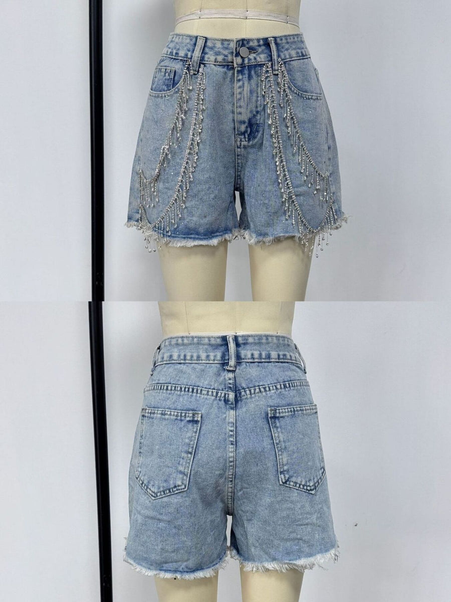 Sky blue denim shorts with rhinestone chain embellishments and frayed hem.