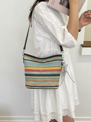 light blue crossbody bag featuring adjustable strap and striped