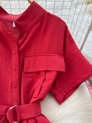 Red belted wide leg romper with button-down front, short sleeves, and chest pocket detail.