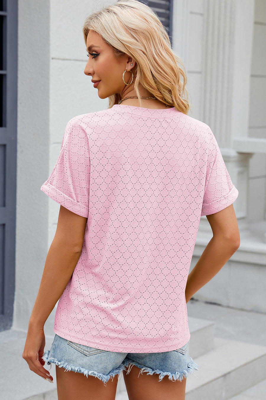 Textured blush pink henley tee with rolled sleeves and diamond eyelet pattern