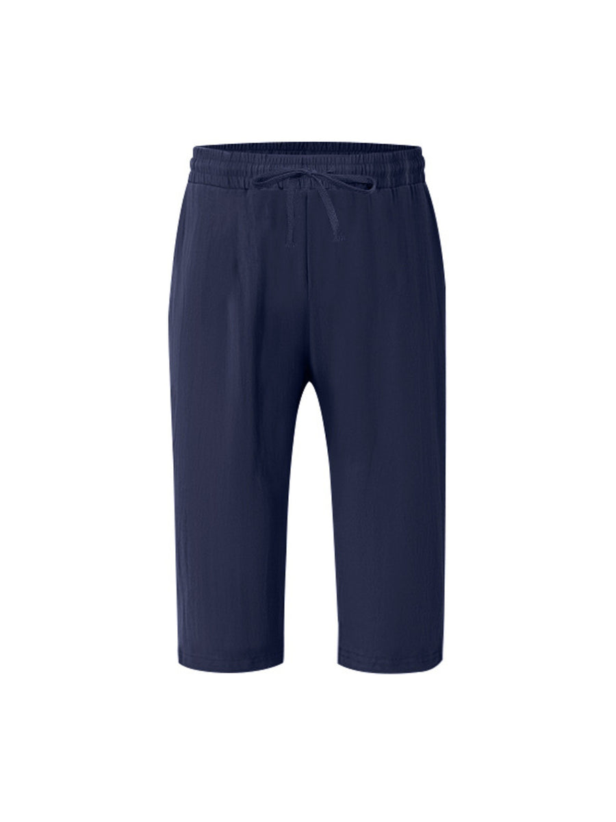 Navy relaxed fit drawstring cropped sweatpants with a casual, loose cut.