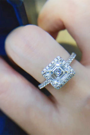 Silver Asscher cut moissanite halo ring with a pavé band.