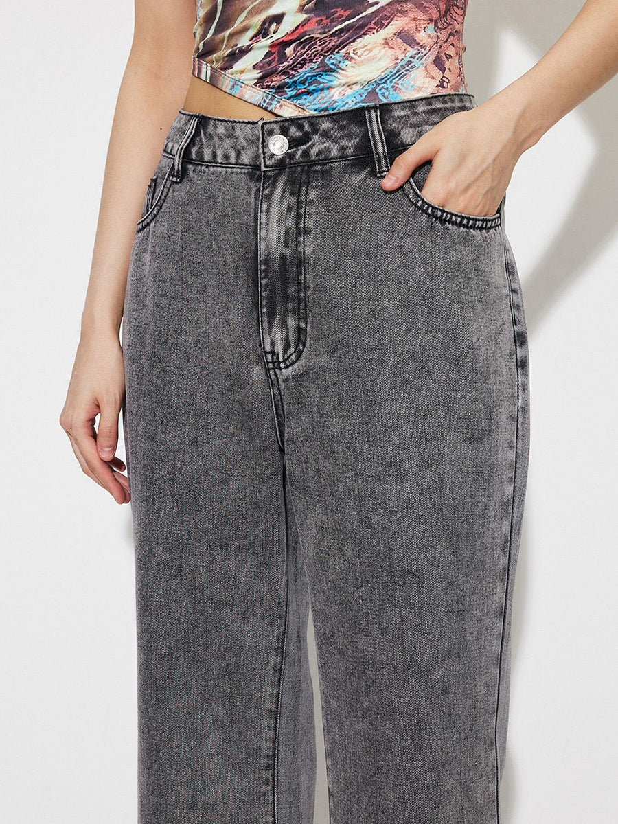 Acid wash high-rise flare jeans in dark gray cotton with button fly and pocket detail.
