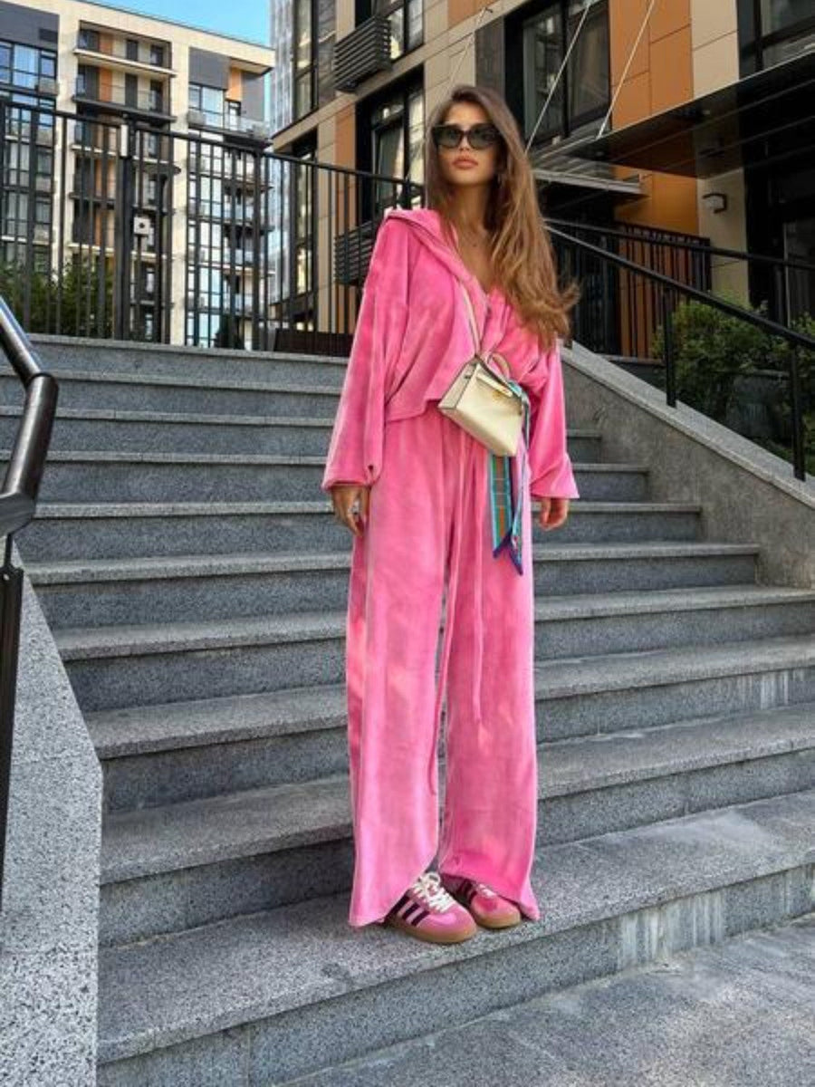 Plush velour lounge set in hot pink with wide leg pants and a hooded jacket.