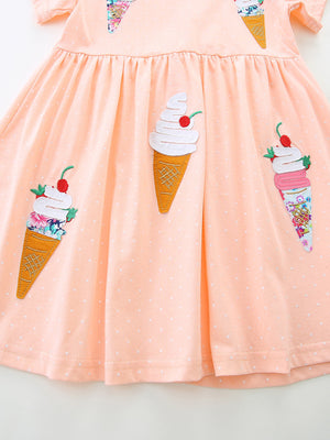Peach cotton toddler dress with polka dots and playful ice cream cone appliques.