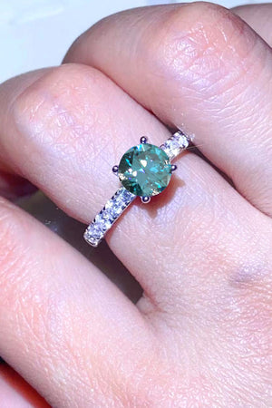 Celestial teal moissanite pavé ring with round center stone and diamond band.