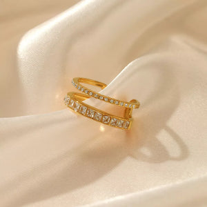 Opulent gold-plated open ring with two bands, one set with square rhinestones, the other with round rhinestones.
