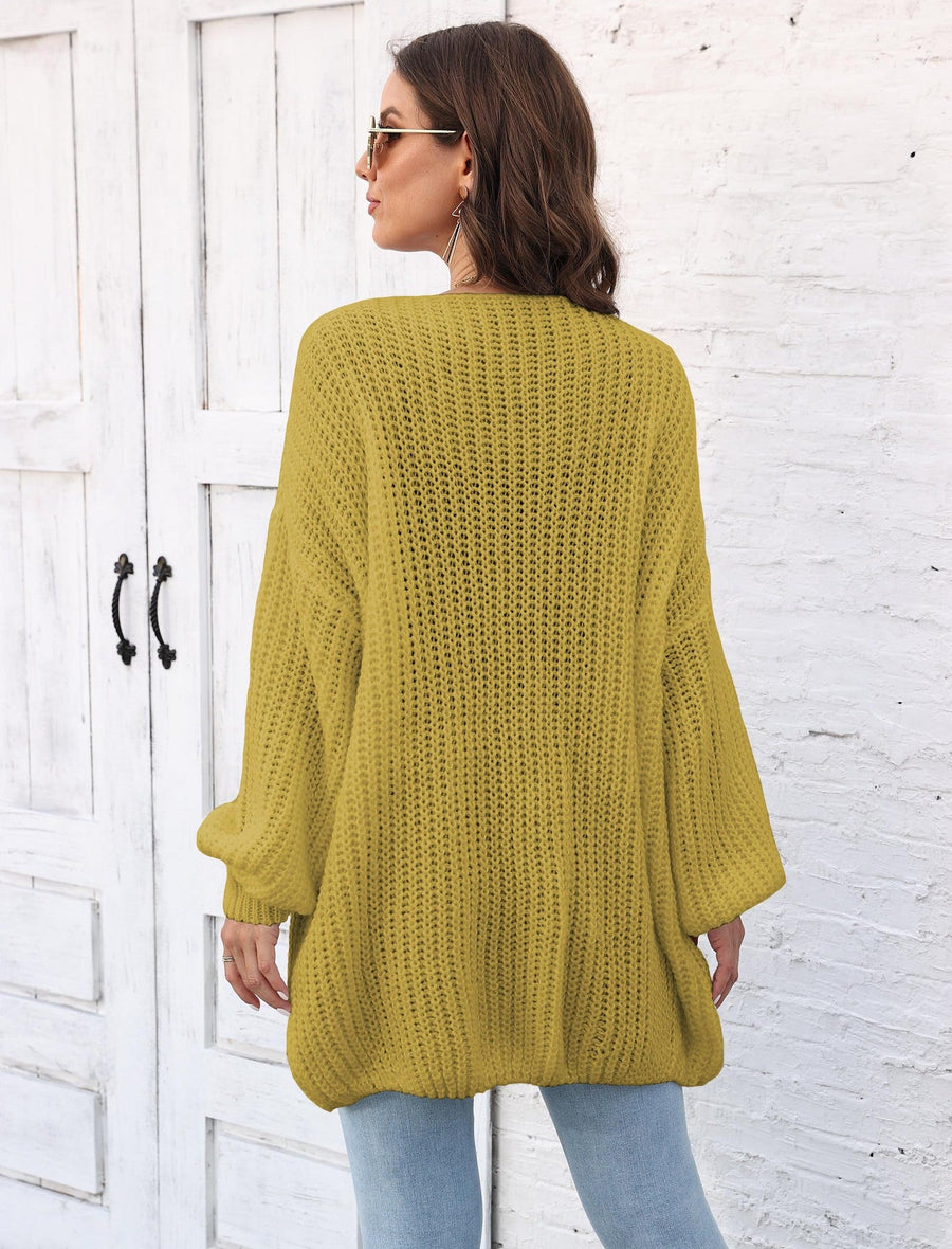 Yellow-green balloon sleeve cardigan with pearl buttons and a textured knit.