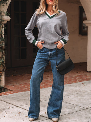 dark green pullover sweater featuring striped trim and striped