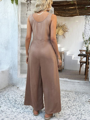 Taupe linen wide-leg jumpsuit with scoop neck and sleeveless design.