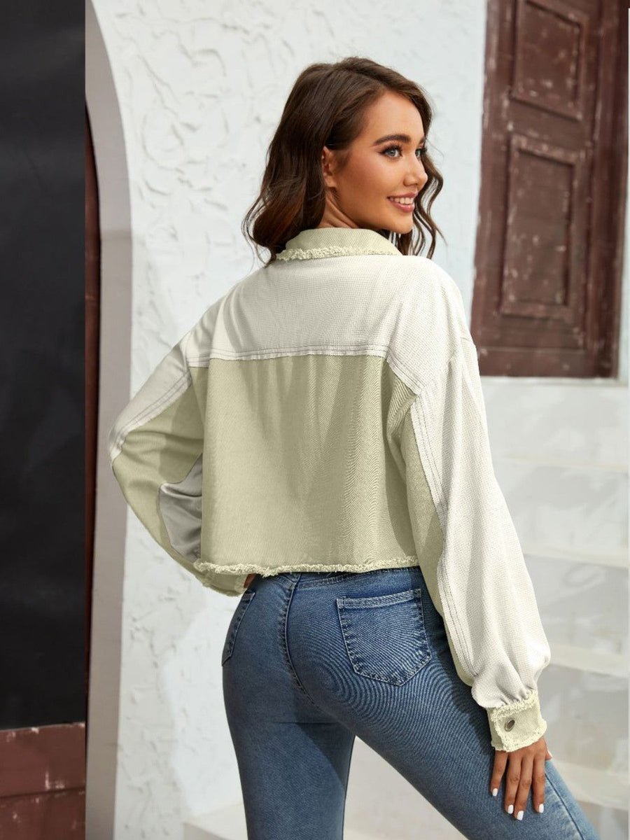 Textured colorblock cropped jacket in matcha green and cream with raw edges and balloon sleeves.