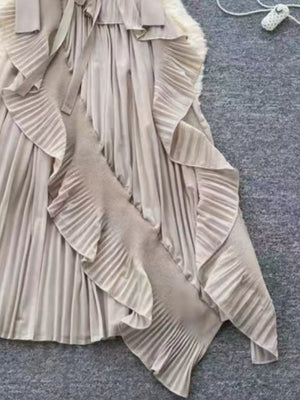 Elegant midi dress in apricot with ruffled pleats and asymmetrical hem.