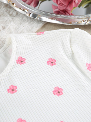 White ribbed knit pajama top with pink floral print and frill trim detail.