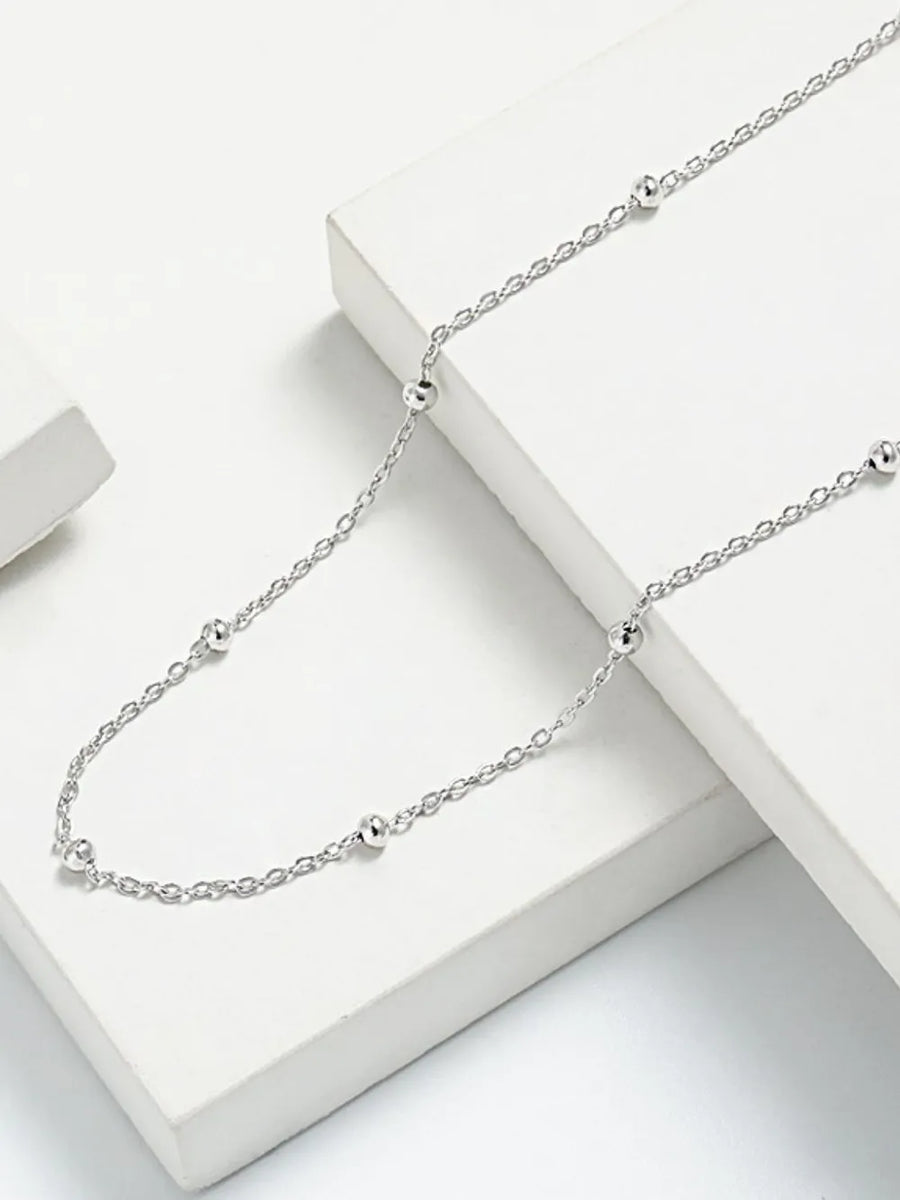 Delicate silver orb chain necklace with small, evenly spaced beads.