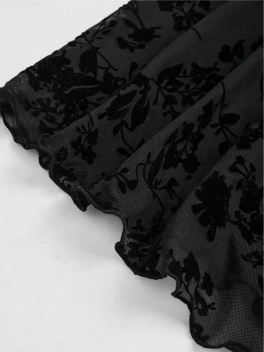 Black lace mini dress with velvet floral pattern and ruffled hem detail.