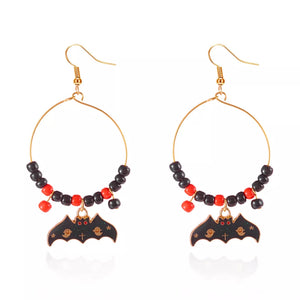 earrings in red with geometric and bat charm