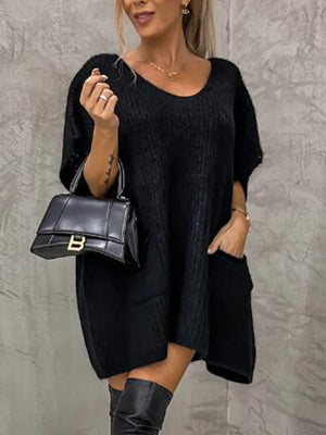 Black knit cocoon dress with V-neck, short sleeves, and patch pockets.