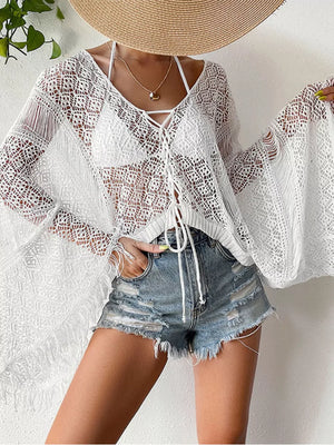 White crochet knit beach cover-up with fringe and lace-up neckline.