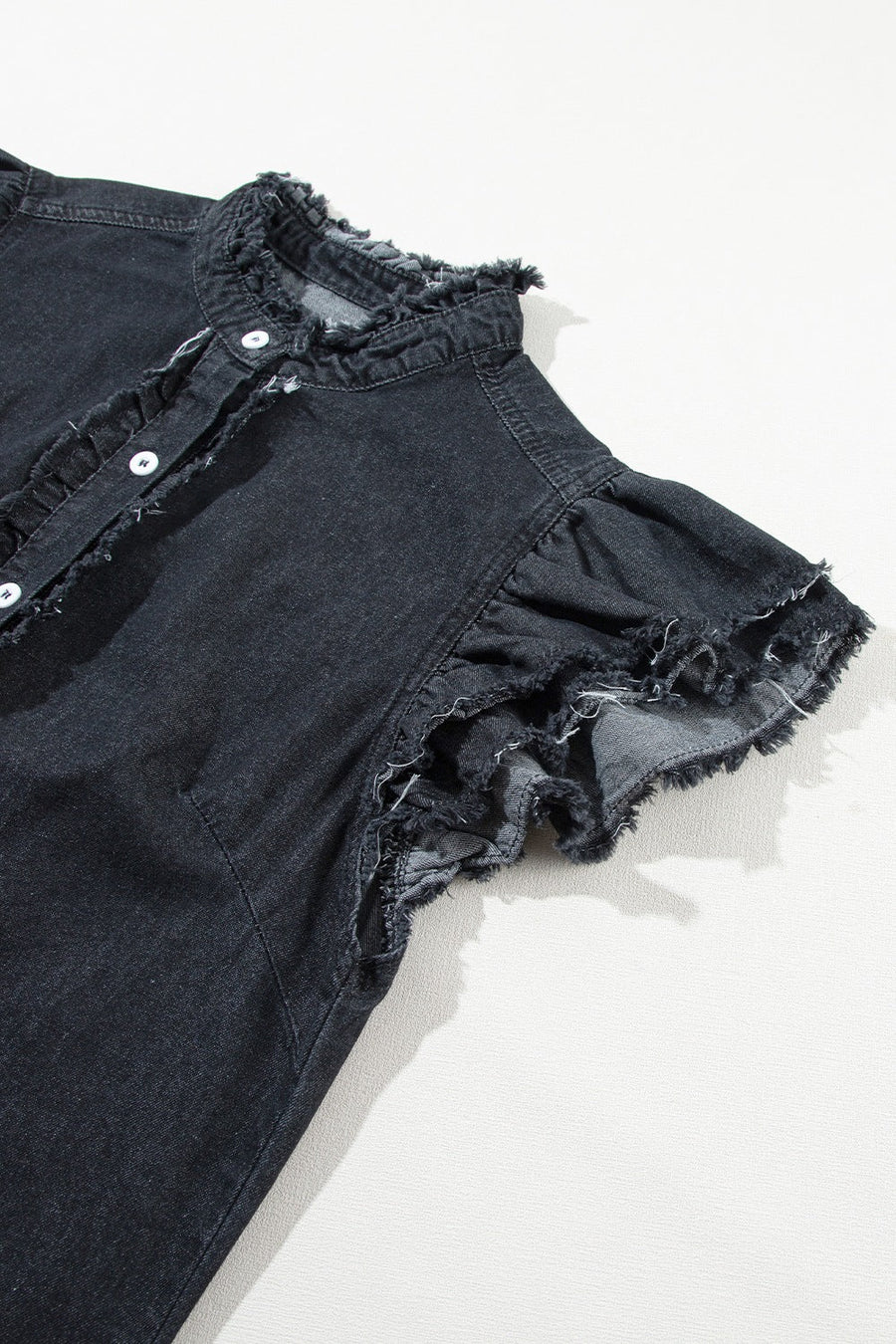 Black denim button-up shirt with frayed ruffle trim on collar and sleeves