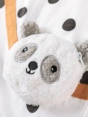 White baby outfit with black polka dots and a plush panda face detail.