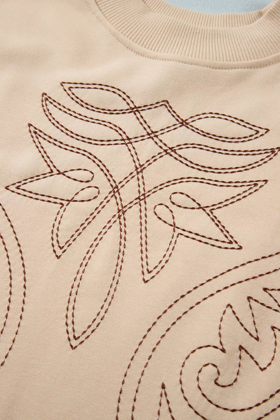 sweatshirt featuring embroidered in Tan with 65% polyester, 35% cotton Care instructions: Machine wash cold texture