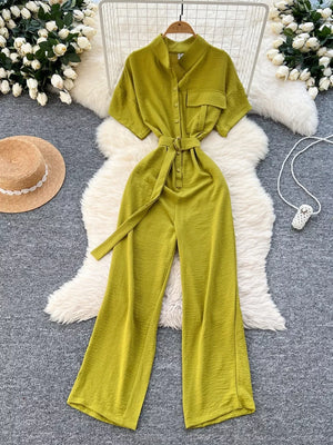 Green belted wide leg romper with short sleeves and button-down front.