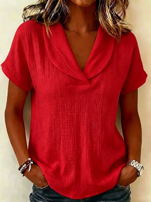 Red textured short sleeve blouse with a wide collar and v-neck.