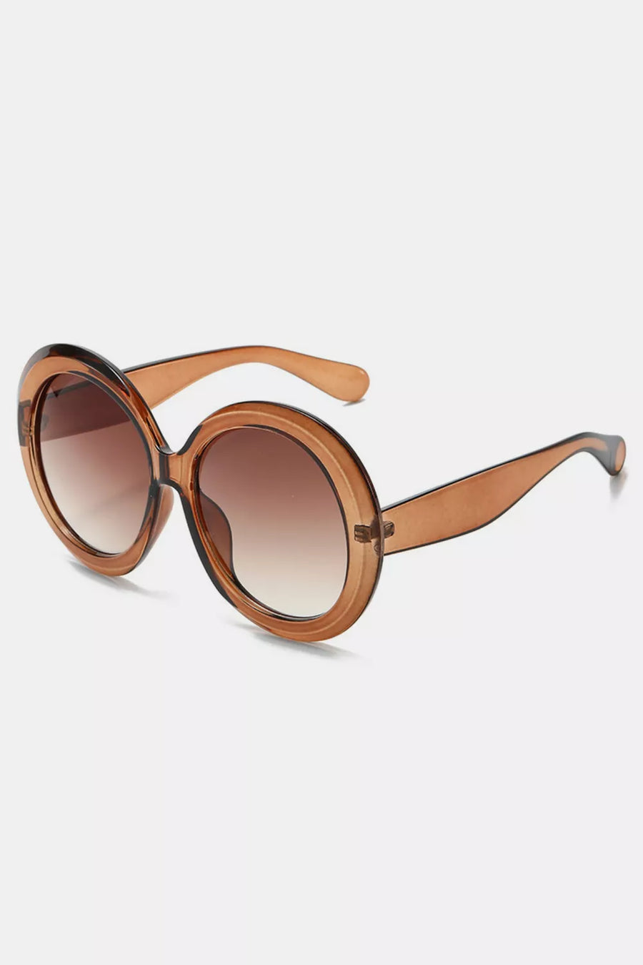 Chic oversized round sunglasses in brown with gradient lenses and translucent brown frames.
