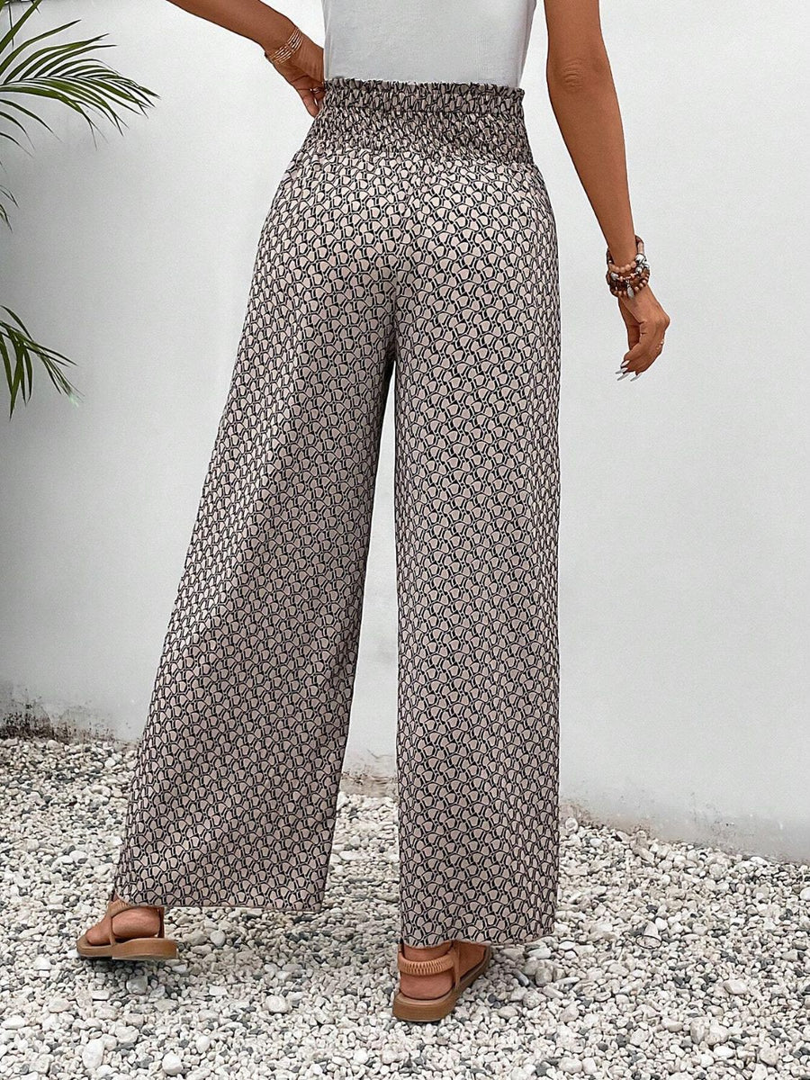 Palazzo pants with a smocked waist and allover geometric print in beige and black.